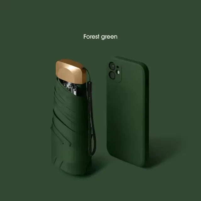 A dark olive green compact folding umbrella is shown against a solid forest green background.
