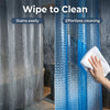 A close-up of a blue 3D crystal texture waterproof shower curtain liner being wiped clean on a shower curtain.