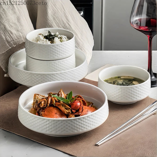 A set of white Japanese ceramic soup bowls containing various savory dishes and a glass of red wine.