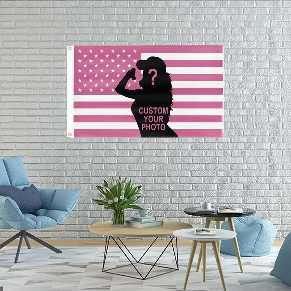 A pink and white striped flag tapestry featuring a silhouette of a woman with a question mark, displayed on a white brick wal