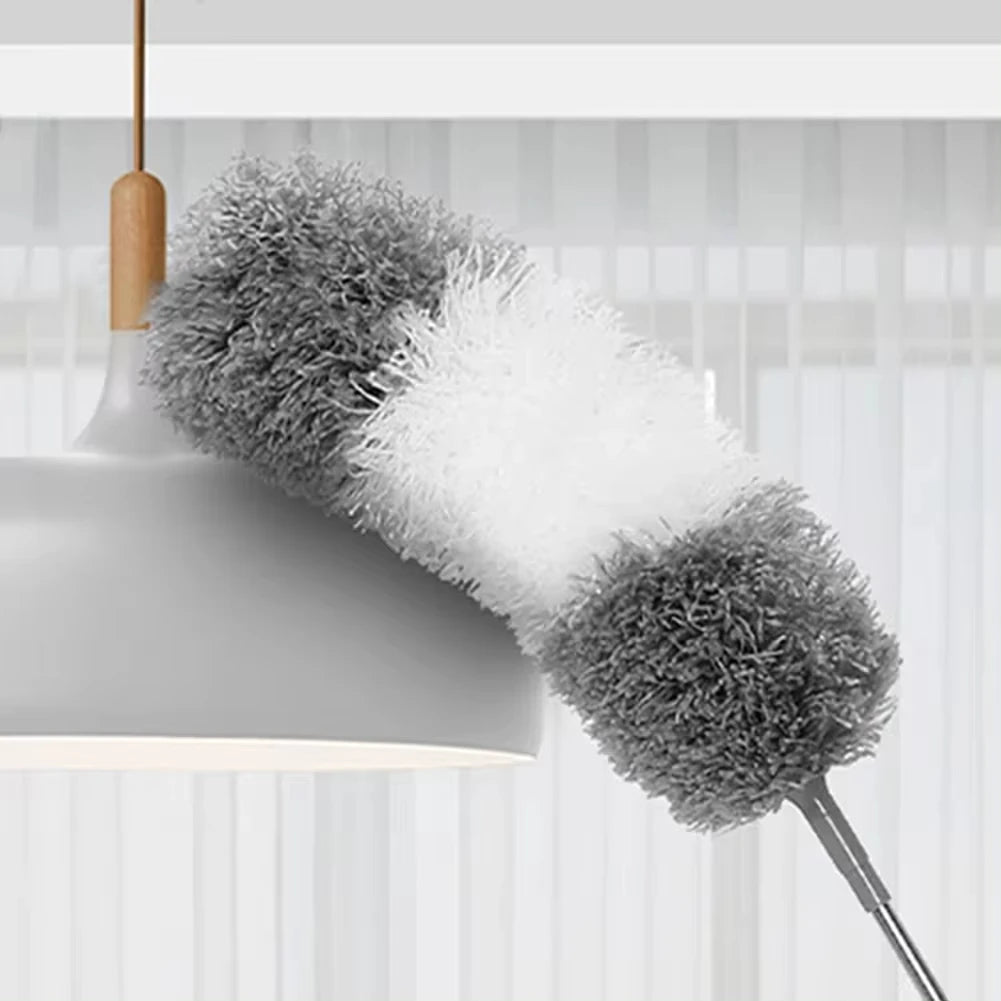 Extendable microfiber duster set with gray and white fluffy heads hanging from a light fixture.