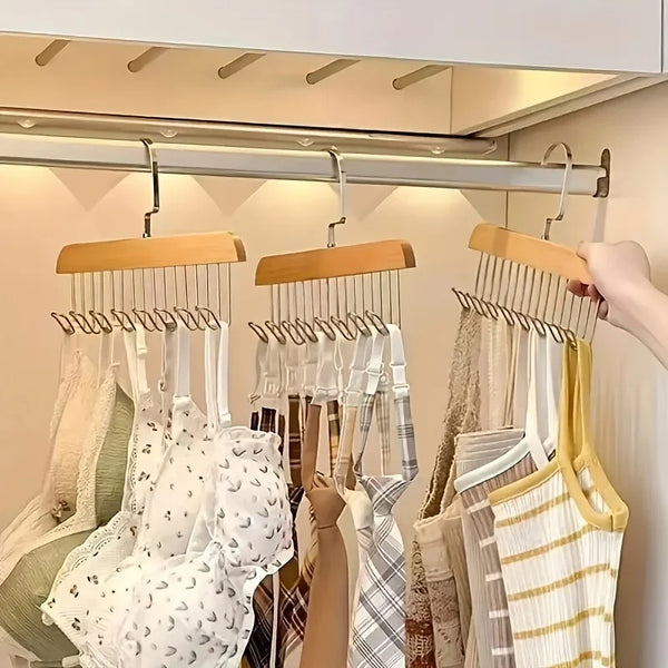 A display of wooden clothes hangers designed for bras and vests, featuring various colors and fabrics.