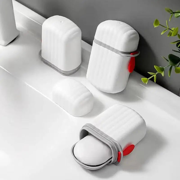 White portable travel soap containers with drain trays arranged on a white surface.