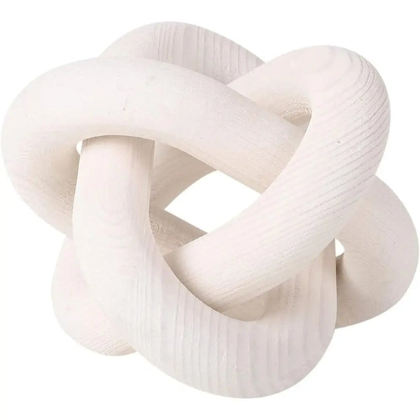 A white, twisted wood knot accent piece for a coffee table.