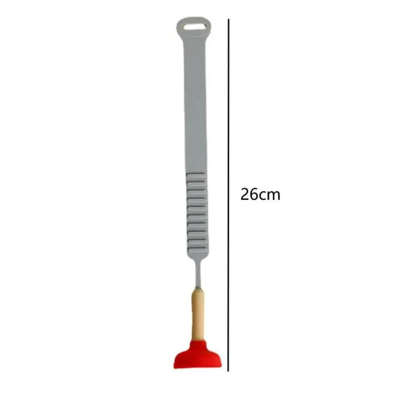 A gray portable toilet lid lifter tool with a handle and a small, red, curved tip.