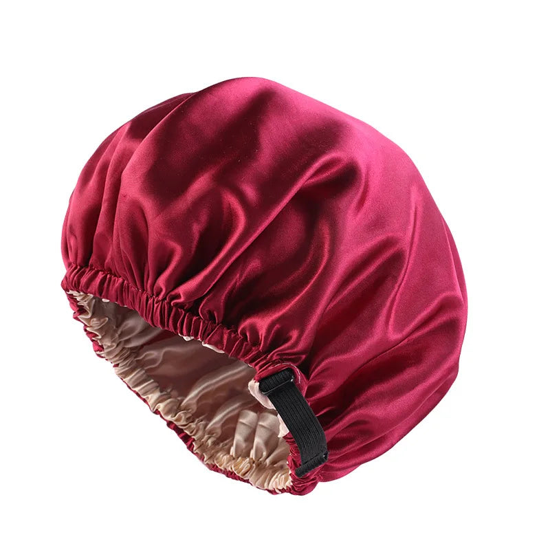 A deep maroon satin sleep cap with a gathered brim and elastic band for hair protection.