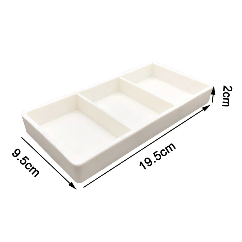 White dental autoclavable cabinet tray organizer with three compartments shown from above.