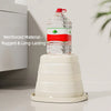 A clear water bottle with a red and green label is placed on a white plastic stand.