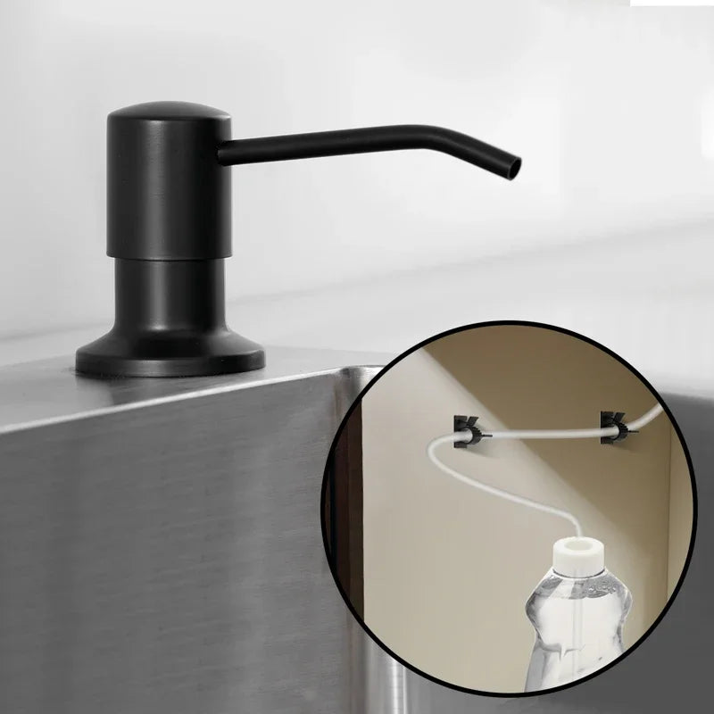 A black faucet with an extension tube is mounted on a stainless steel sink.