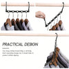A set of black plastic clothes hangers with five closed holes for closet organization.