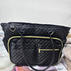 Black quilted multi-pocket tote bag with gold trim and leather strap