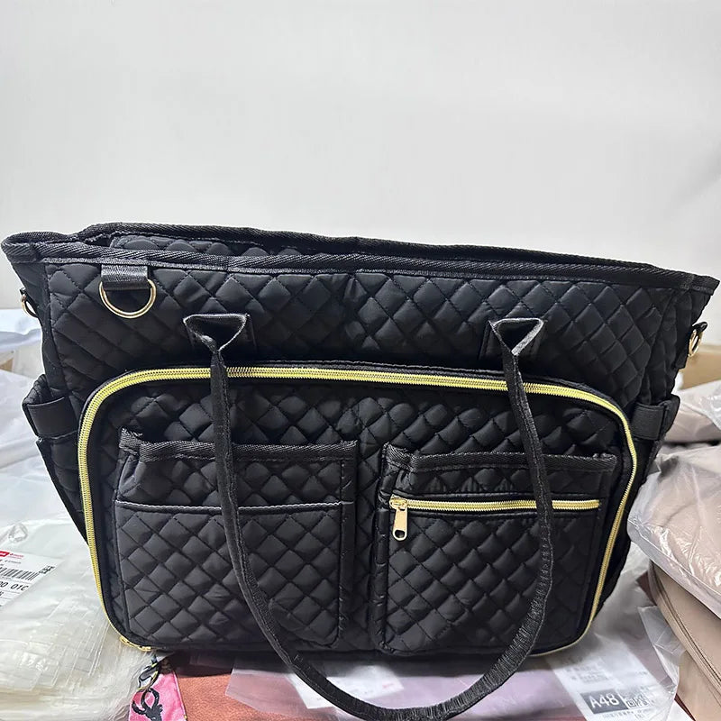 Black quilted multi-pocket tote bag with gold trim and leather strap