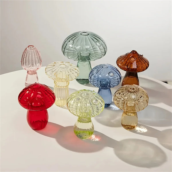 A collection of colorful glass mushroom-shaped vases in various shades including pink, green, blue, and amber.