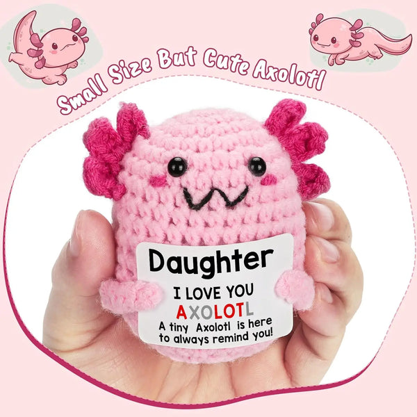 Handmade pink crochet axolotl figurine with a tag that reads I love you daughter