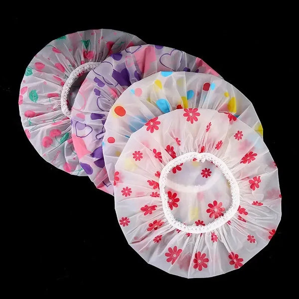 A set of pink and purple decorative waterproof shower caps with floral patterns.