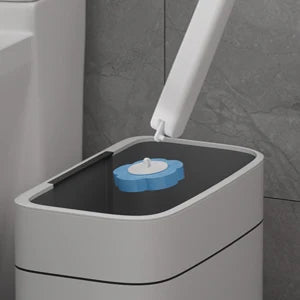 A white toilet brush and holder set with a blue cleaning brush visible on the lid.