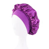 A purple satin wide-brim sleeping bonnet displayed on a white mannequin head.