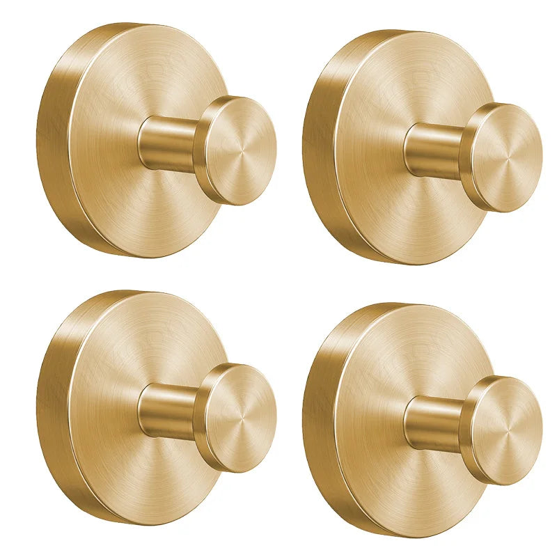 A round, brass-toned stainless steel suction cup towel rack with a cylindrical handle.