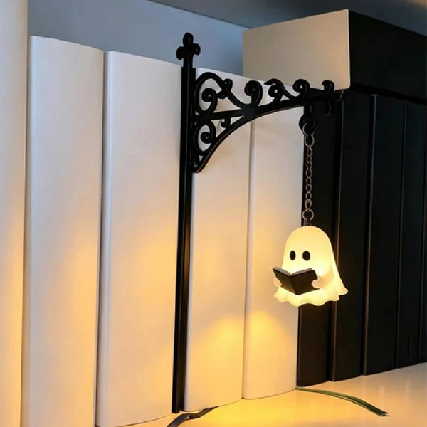 A vintage library lantern desk lamp featuring a black wrought iron arch and an illuminated white ghost light.