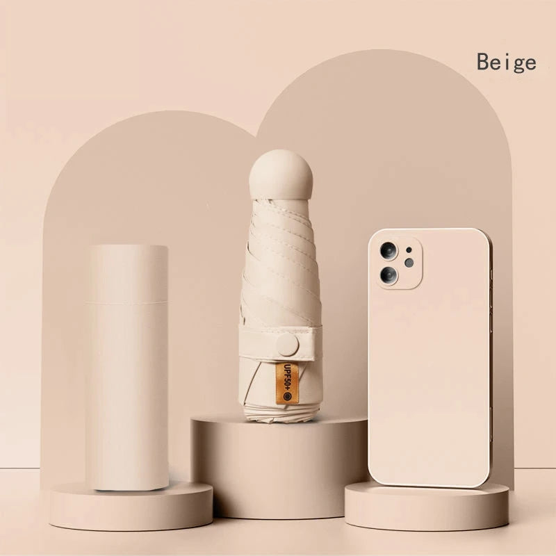 A beige folding UV protection umbrella and a smartphone are displayed against a light background.