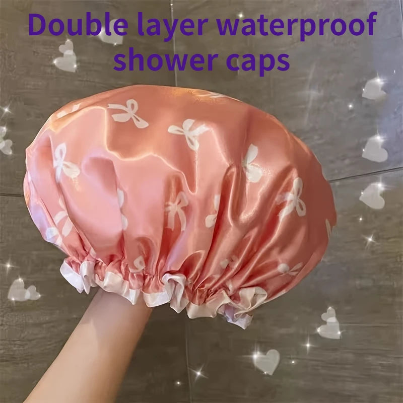 A pink satin double layer waterproof shower cap with white butterfly patterns shown from above.