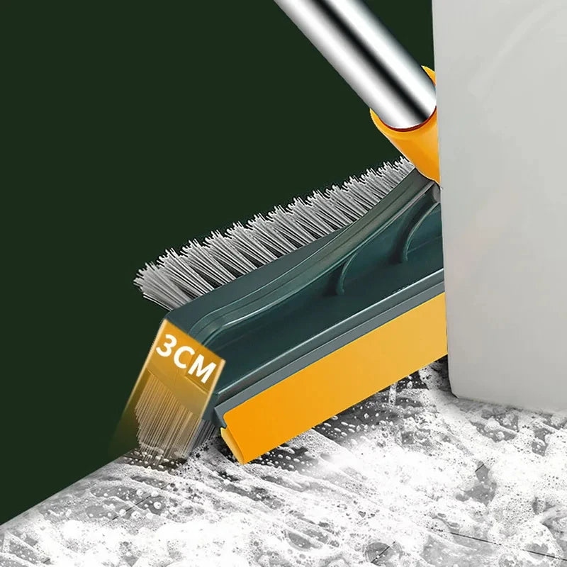 A close-up of a green and yellow 3-in-1 magic scrub brush with bristles resting on a white surface.