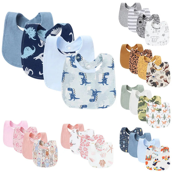 A collection of soft cotton baby bibs in various colors and cute dinosaur, animal, and floral prints.