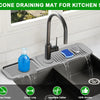 A silicone draining mat for a kitchen sink is shown installed under a faucet, demonstrating its 5" slope design, 24 inch leng