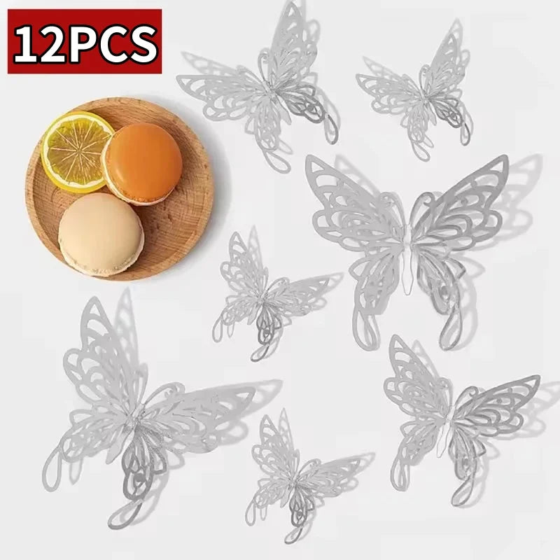 Twelve silver decorative butterfly wall stickers displayed next to a slice of orange and an orange sphere.