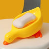 A yellow duck-shaped soap dish with a white bar of soap resting inside it.