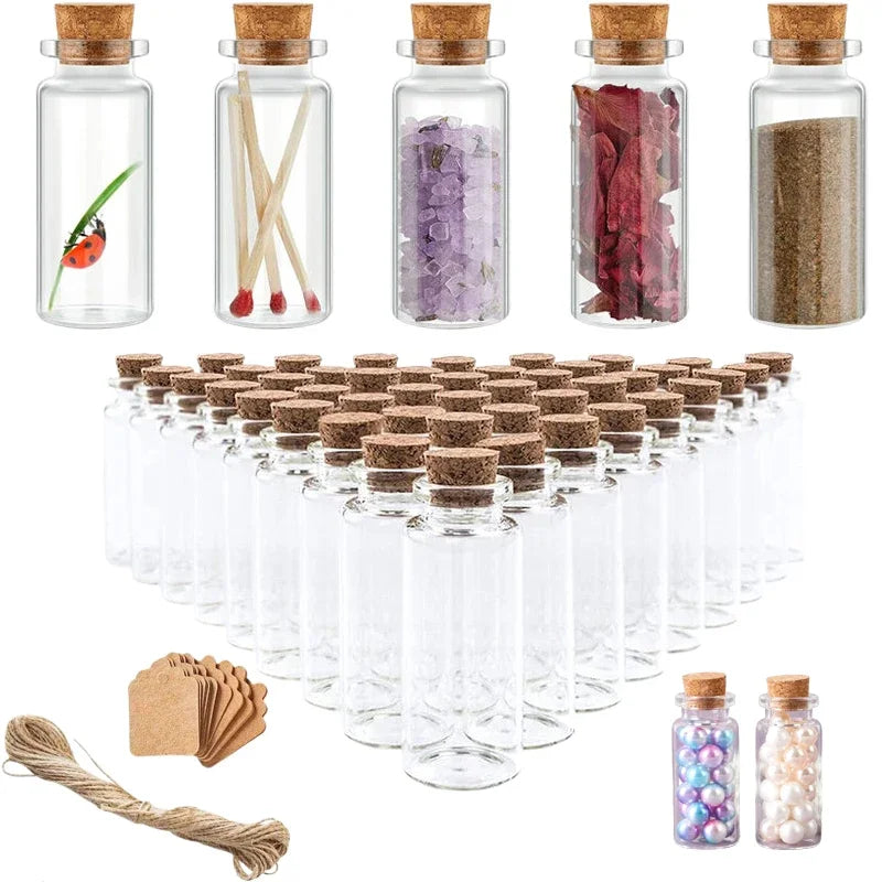 A set of ten mini glass bottles with corks, some filled with colored materials like glitter and dried petals.