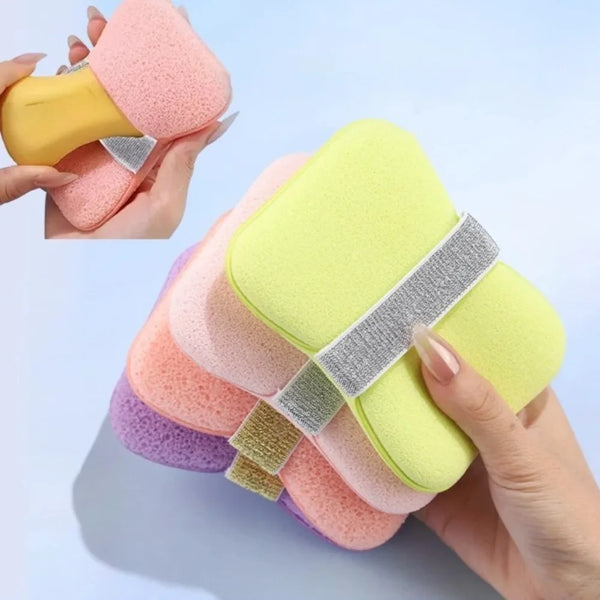 A hand holds a stack of multi-sided exfoliating body soap bags in various pastel colors like pink, yellow, and purple.