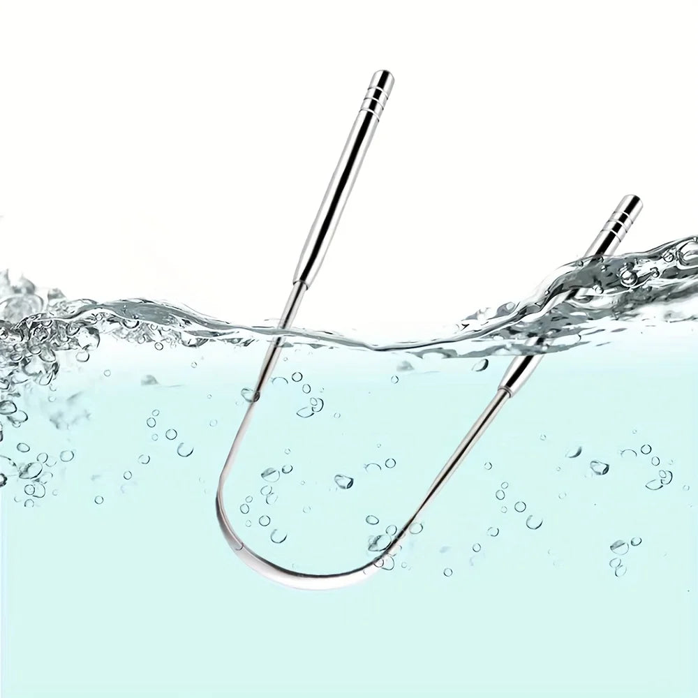 A stainless steel tongue scraper set is shown submerged in clear water with ripples and bubbles.