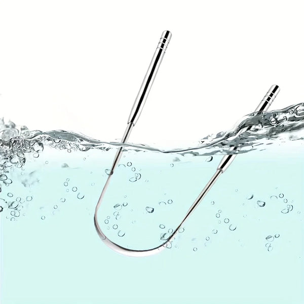 A stainless steel tongue scraper set is shown submerged in clear water with ripples and bubbles.