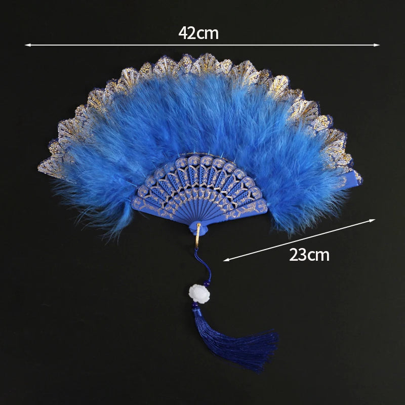A bright blue lace fabric folding hand fan with a feathered edge and tassel.