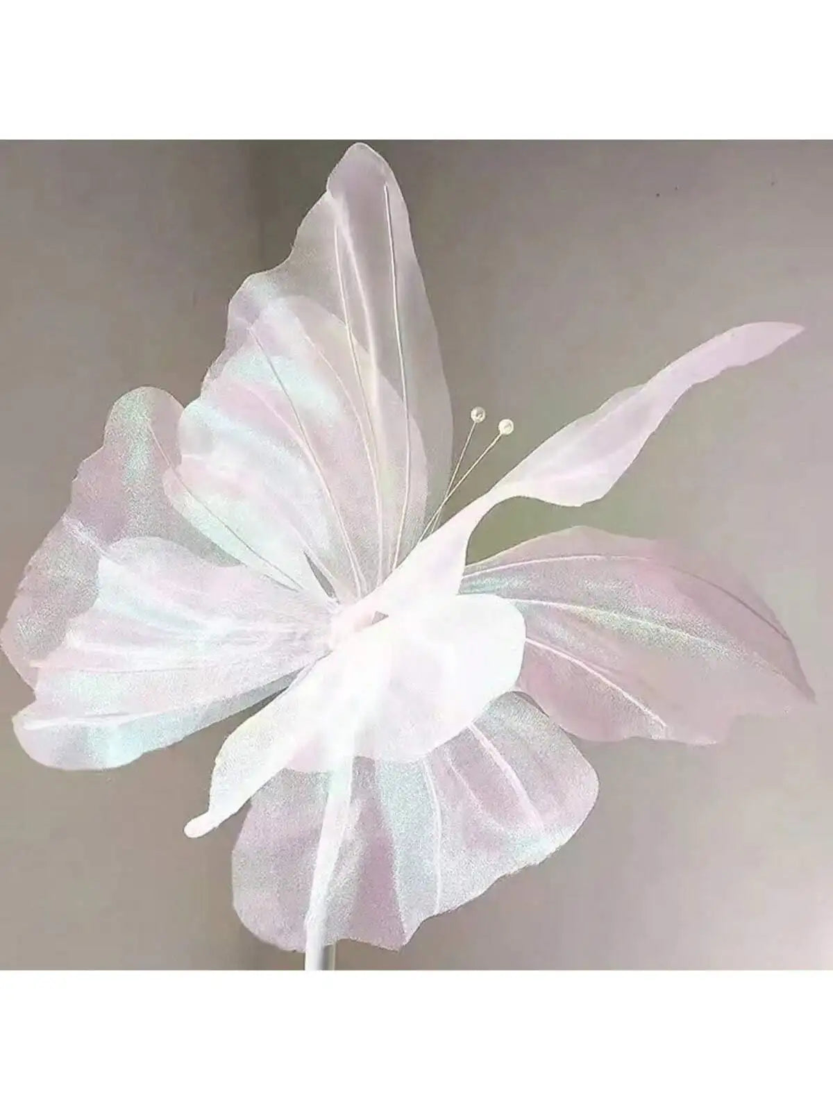 A delicate, translucent white and pink 3D simulated butterfly decoration with delicate wings.