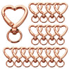A set of rose gold heart-shaped spring hook keychains.