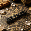 A black willow stick night light projector resting on an antique brass zodiac-themed surface with crystals.