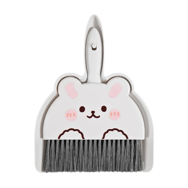A white cartoon animal broom and dustpan set with a cute face design.