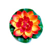 A vibrant artificial lotus flower with orange and red petals set against a green leaf.