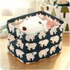 A white rabbit figurine is placed inside a dark fabric storage basket with a patterned lining.