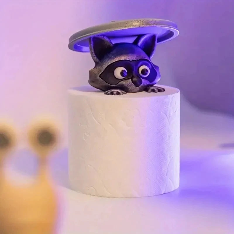 A decorative toilet paper holder shaped like a cat with purple and gray features.