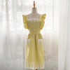 A yellow cotton linen kitchen apron with lace detailing displayed on a mannequin.