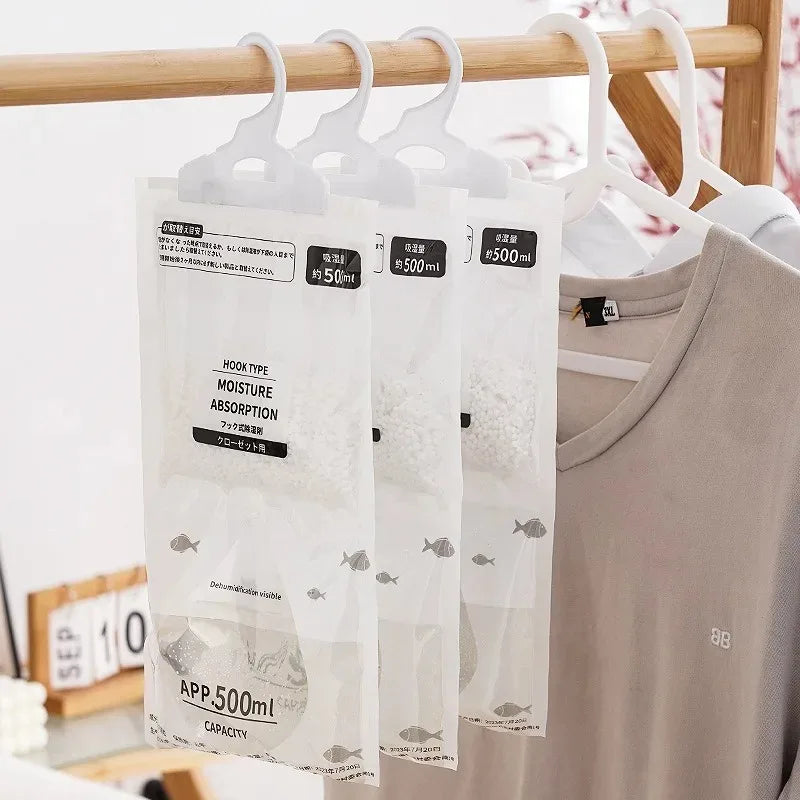 Clear hanging bags with hooks for moisture absorption used in a closet or wardrobe