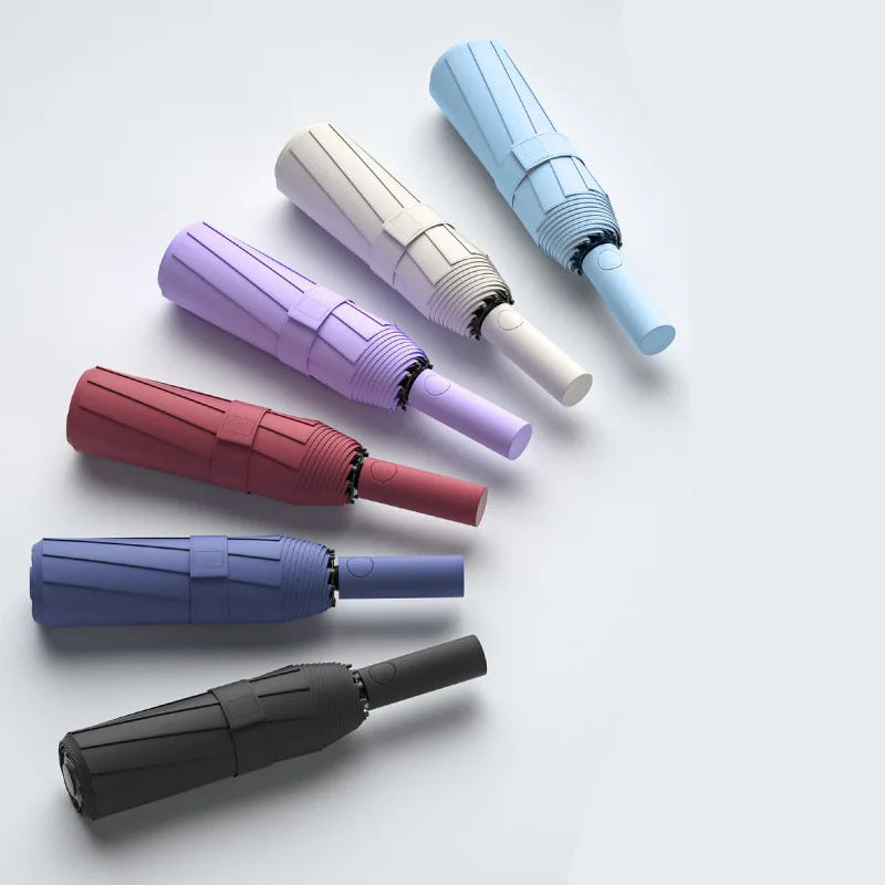 A collection of heavy-duty automatic windproof umbrellas in various pastel and dark colors.