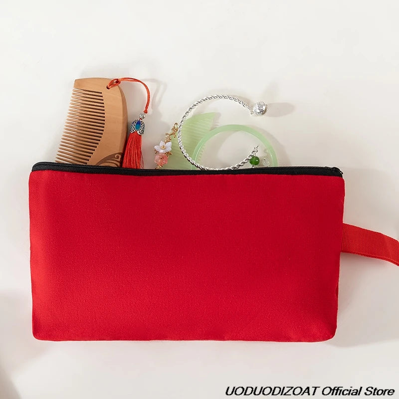 A red zippered pouch containing various cosmetic and stationery items like a comb, jewelry, and green accessories.