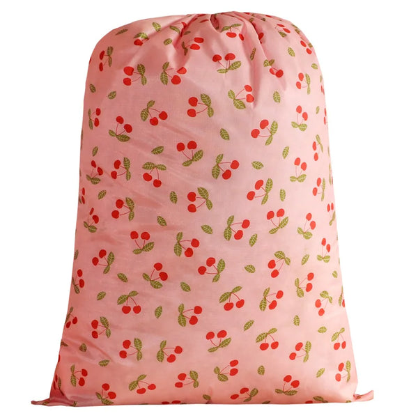 A pink drawstring storage bag patterned with small red and green berries.