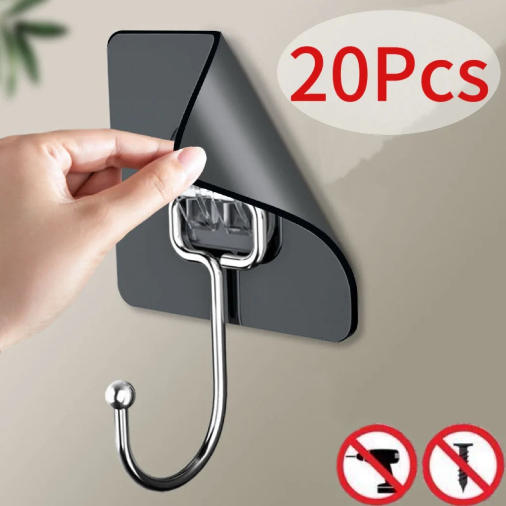 A hand is installing a self-adhesive rotating wall hook onto a dark gray surface, demonstrating the product's use.