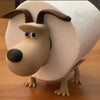 A decorative toilet paper holder shaped like a dog with brown ears and light tan fur.
