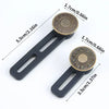 A pair of black adjustable button extenders with brass accents shown against a white background.